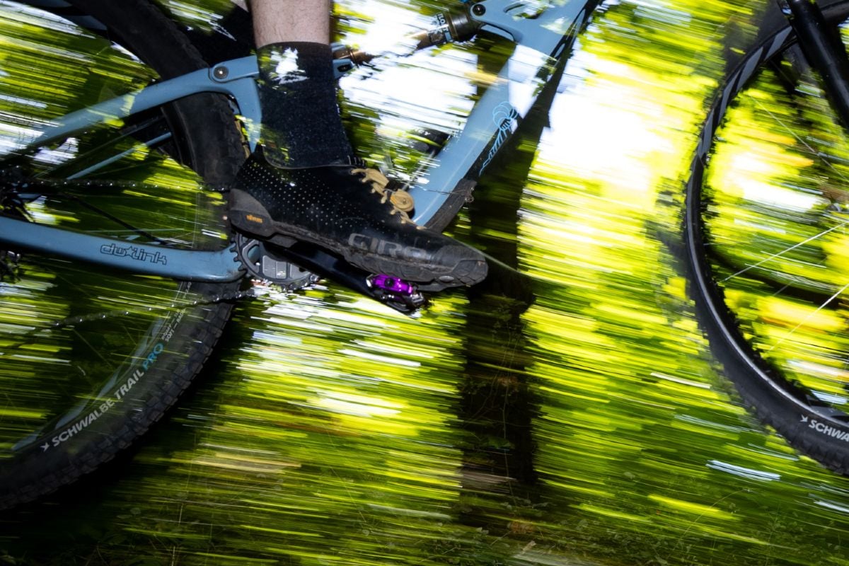 Wolf Tooth CTRL Trail pedal in mid air with motion blur