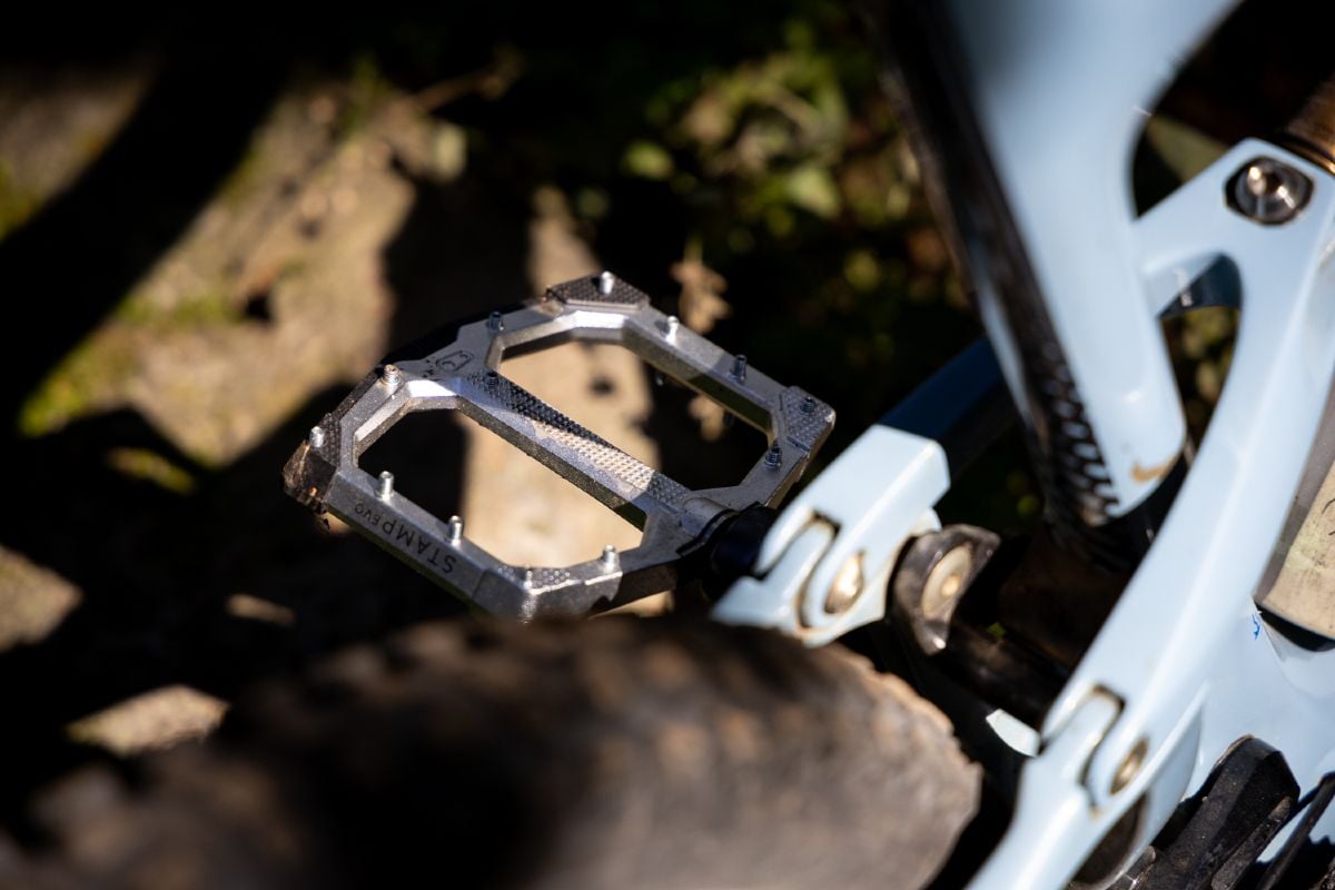 Crank Bros Stamp EVO pedal mounted to a bike in the woods